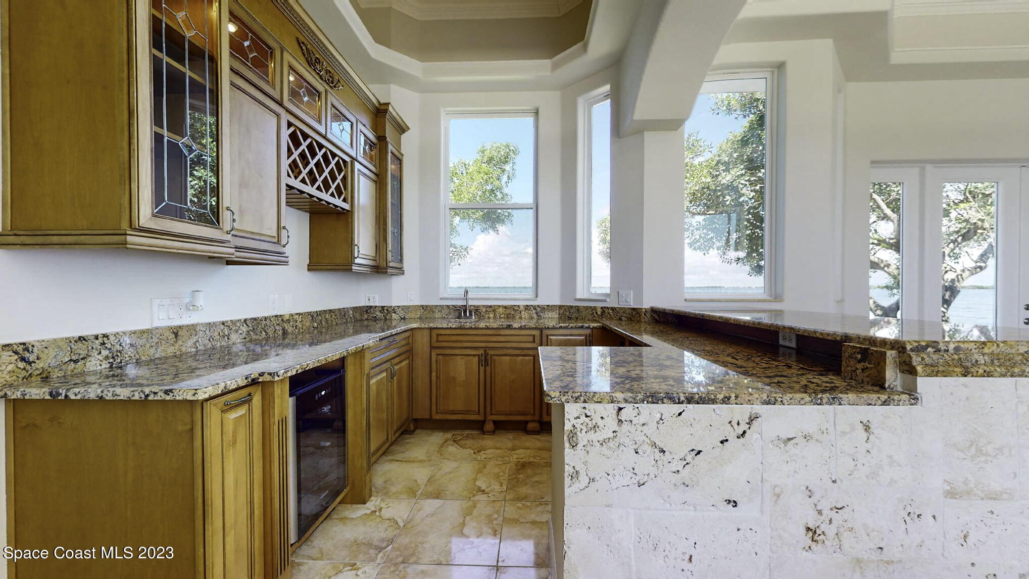 21 West Point Drive, Unit 101 Cocoa Beach, FL 32931 - Photo 20 of 59 a kitchen with granite countertop a sink and a stove