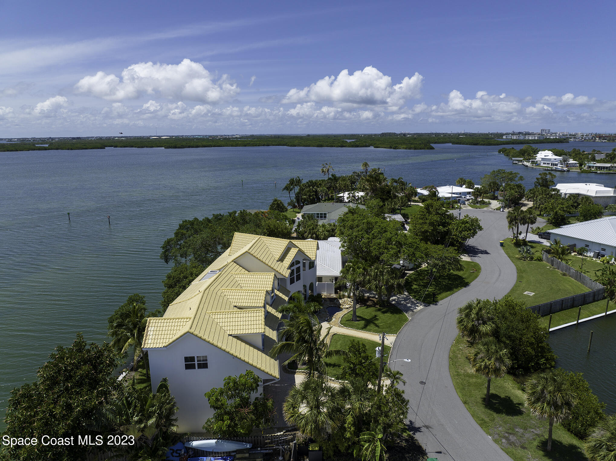 21 West Point Drive, Unit 101 Cocoa Beach, FL 32931 - Photo 2 of 59 an aerial view of a house with a garden and lake view