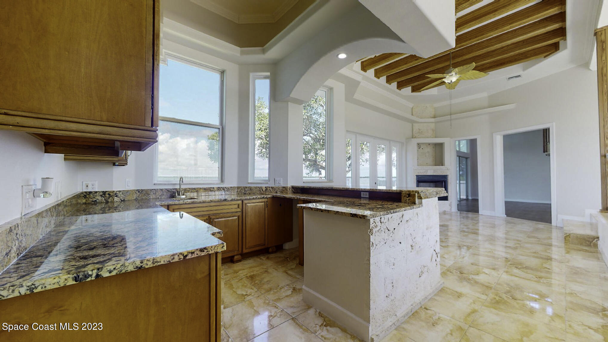 21 West Point Drive, Unit 101 Cocoa Beach, FL 32931 - Photo 21 of 59 a kitchen with granite countertop a sink a counter top space and cabinets