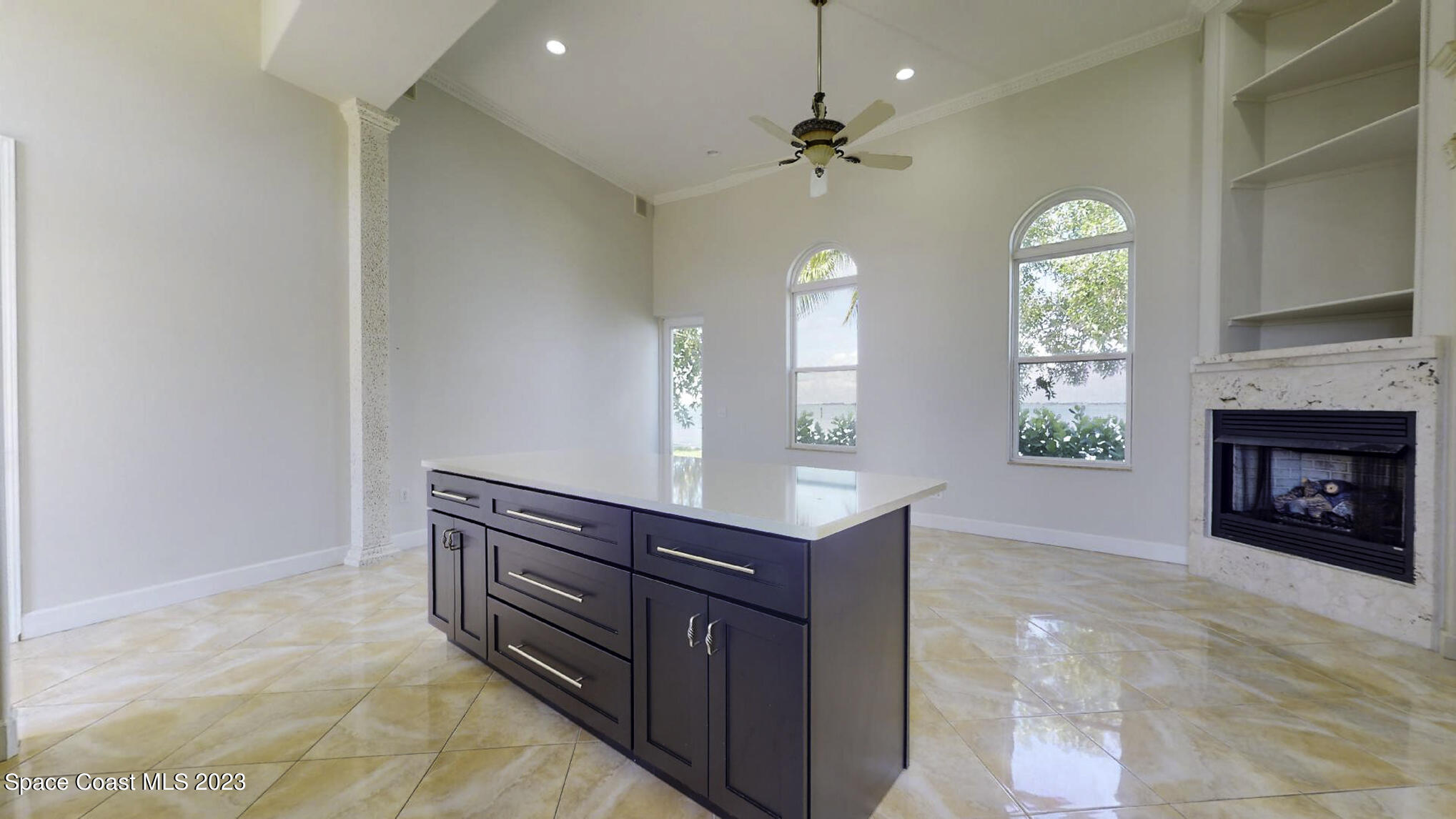 21 West Point Drive, Unit 101 Cocoa Beach, FL 32931 - Photo 22 of 59 a living room with furniture and a fireplace