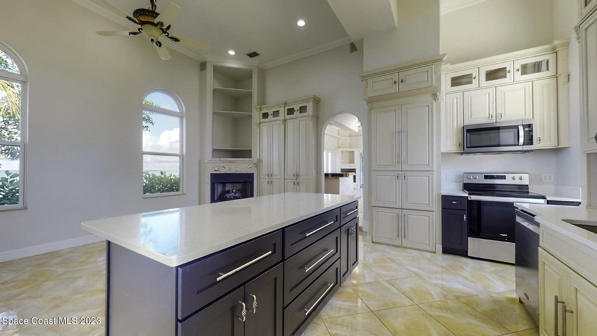 21 West Point Drive, Unit 101 Cocoa Beach, FL 32931 - Photo 23 of 59 a kitchen with stainless steel appliances a sink stove and refrigerator
