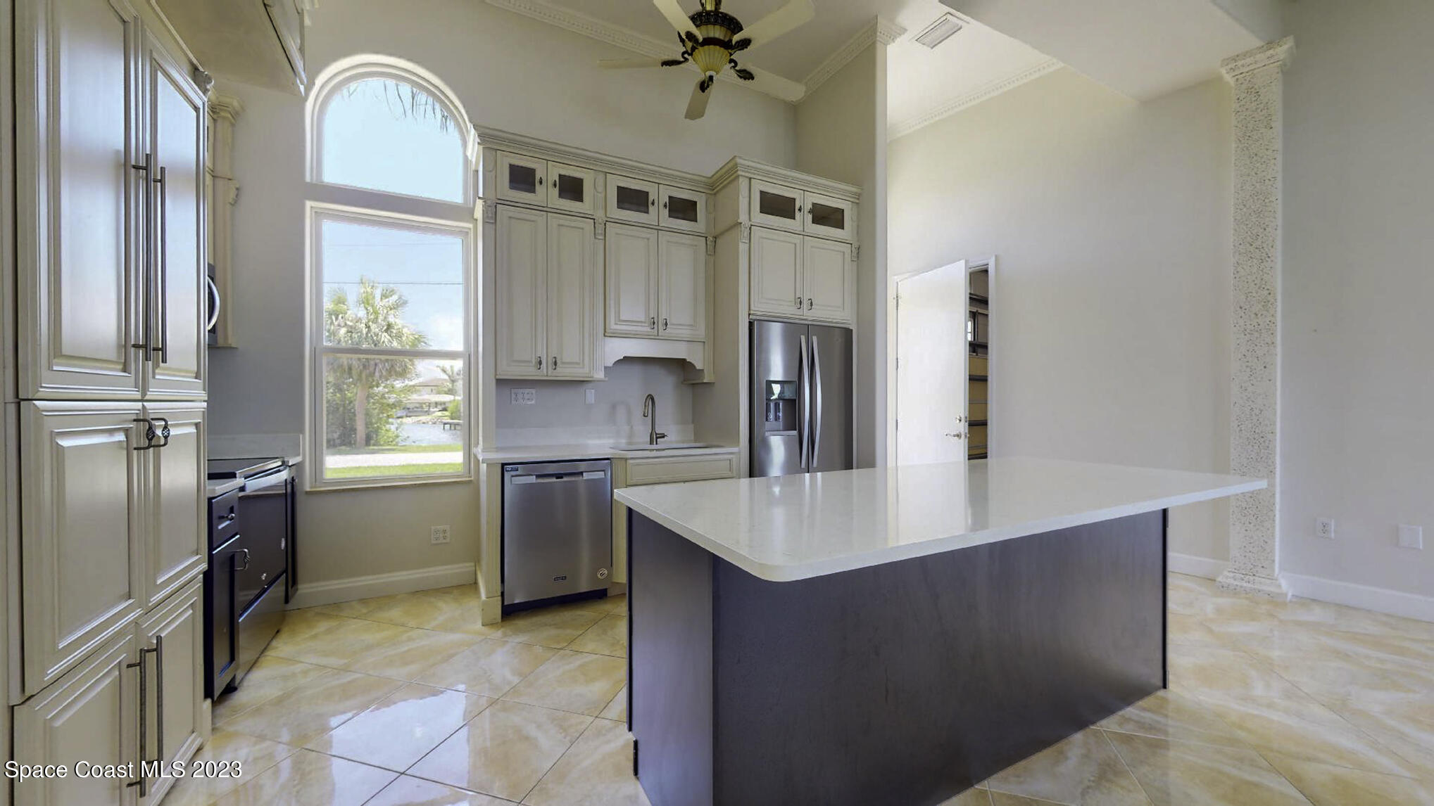 21 West Point Drive, Unit 101 Cocoa Beach, FL 32931 - Photo 25 of 59 a large kitchen with stainless steel appliances a refrigerator a sink dishwasher a oven with white cabinets and wooden floor