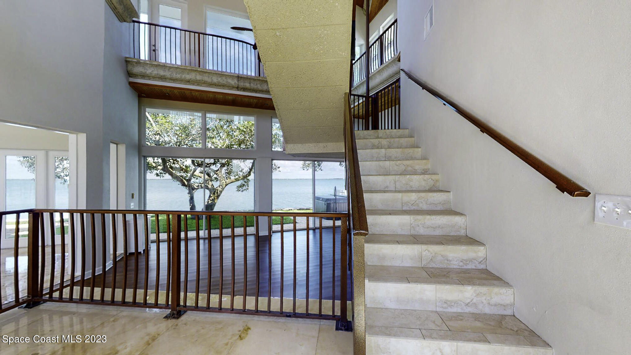 21 West Point Drive, Unit 101 Cocoa Beach, FL 32931 - Photo 28 of 59 a view of staircase with lots of frames on wall