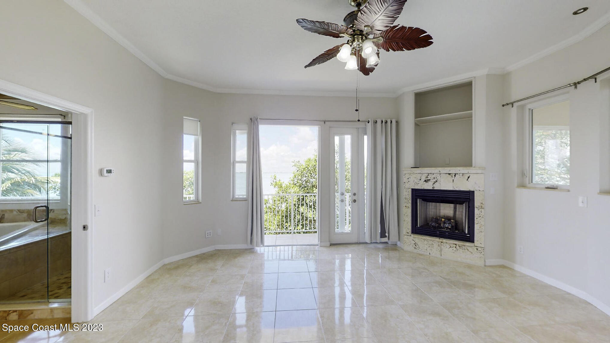 21 West Point Drive, Unit 101 Cocoa Beach, FL 32931 - Photo 31 of 59 a view of an empty room with a fireplace and a window