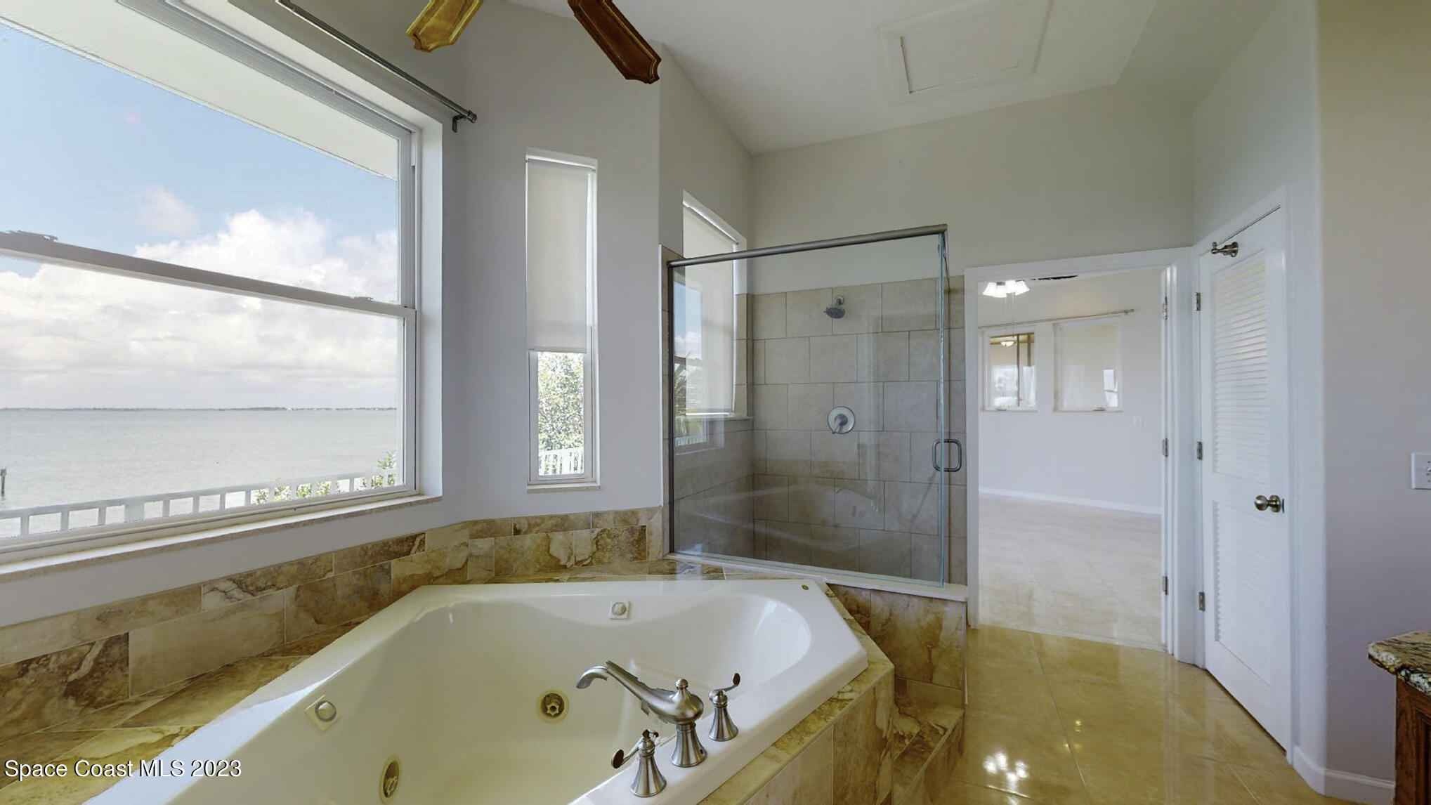 21 West Point Drive, Unit 101 Cocoa Beach, FL 32931 - Photo 34 of 59 a bathroom with a tub and a shower