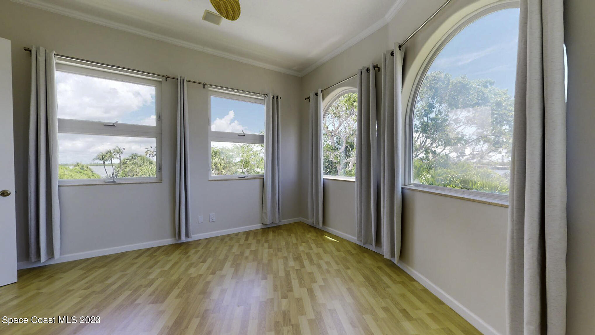 21 West Point Drive, Unit 101 Cocoa Beach, FL 32931 - Photo 37 of 59 a view of empty room with wooden floor and outer view