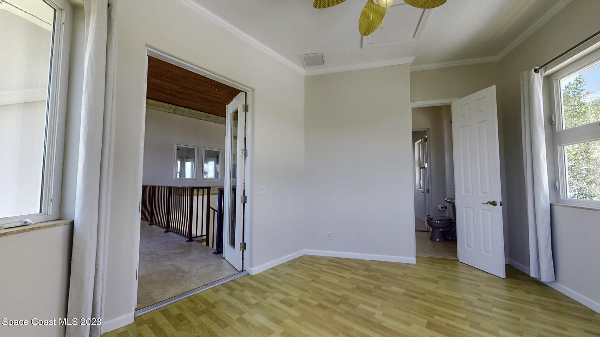 21 West Point Drive, Unit 101 Cocoa Beach, FL 32931 - Photo 38 of 59 a view of hallway with livingroom and wooden floor