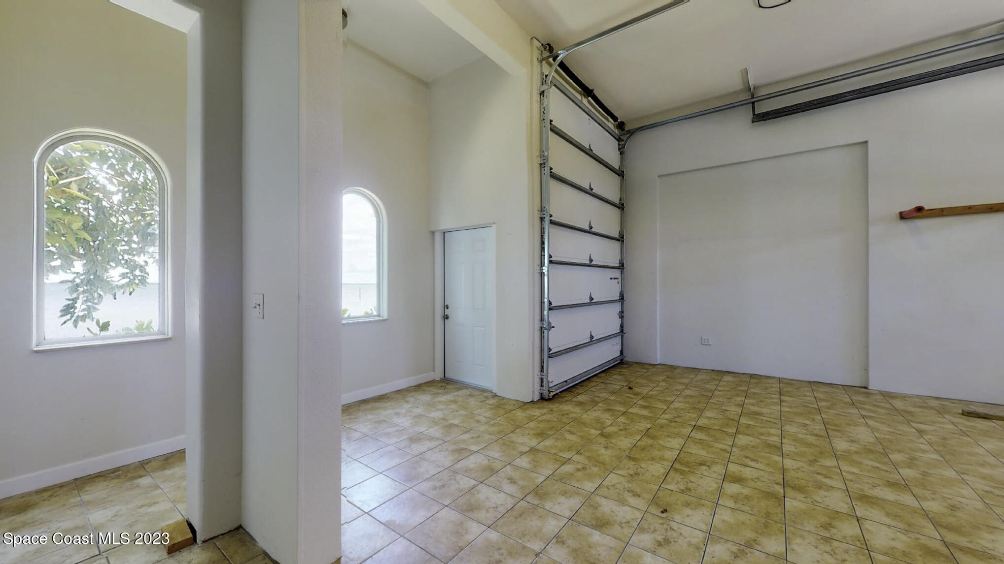 21 West Point Drive, Unit 101 Cocoa Beach, FL 32931 - Photo 44 of 59 a view of a room with window and brick walls