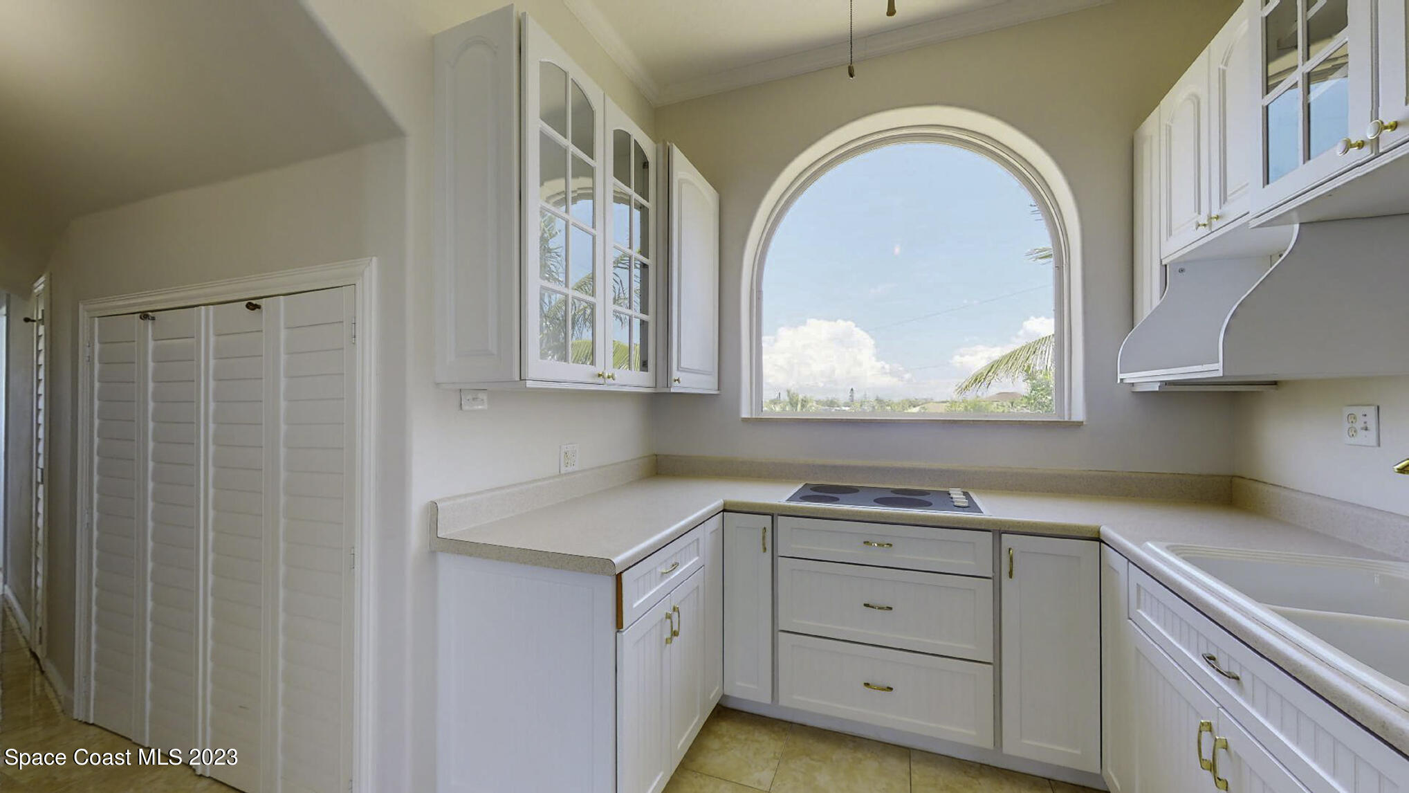 21 West Point Drive, Unit 101 Cocoa Beach, FL 32931 - Photo 49 of 59 a view of a kitchen with a sink and cabinets