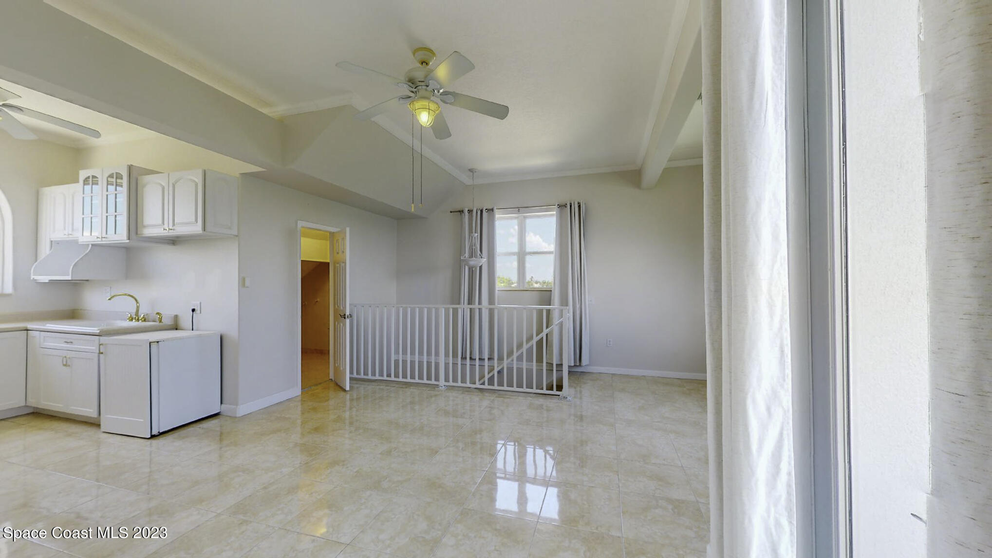 21 West Point Drive, Unit 101 Cocoa Beach, FL 32931 - Photo 51 of 59 a view of an empty room with window and cabinet