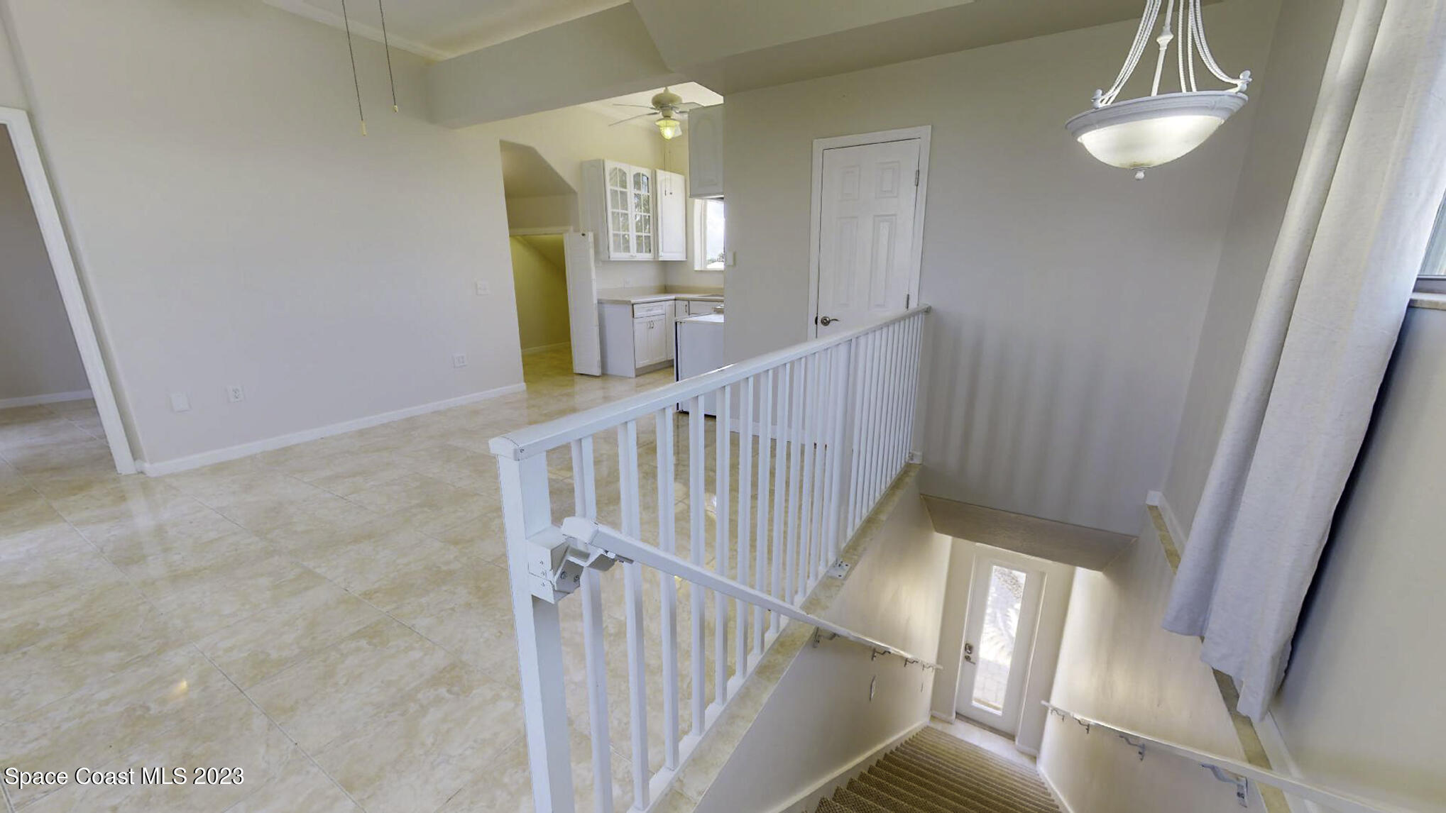 21 West Point Drive, Unit 101 Cocoa Beach, FL 32931 - Photo 54 of 59 a view of staircase with railing and a chandelier