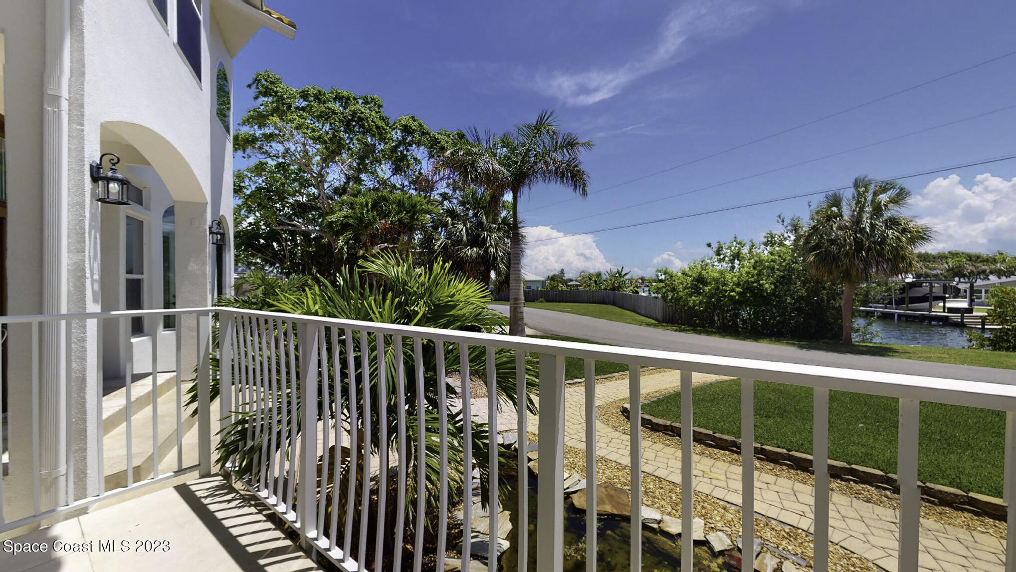 21 West Point Drive, Unit 101 Cocoa Beach, FL 32931 - Photo 58 of 59 a view of balcony with wooden floor and fence