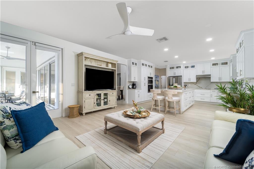 1257 Southeast Brewster Place Stuart, FL 34997 - Photo 20 of 35 a living room with furniture and a flat screen tv