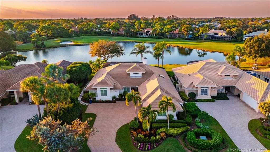 1257 Southeast Brewster Place Stuart, FL 34997 - Photo 2 of 35 an aerial view of a house with outdoor space and lake view