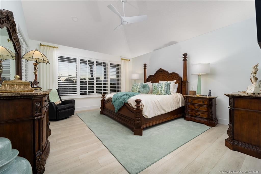 1257 Southeast Brewster Place Stuart, FL 34997 - Photo 21 of 35 a bedroom with a bed and wooden floor