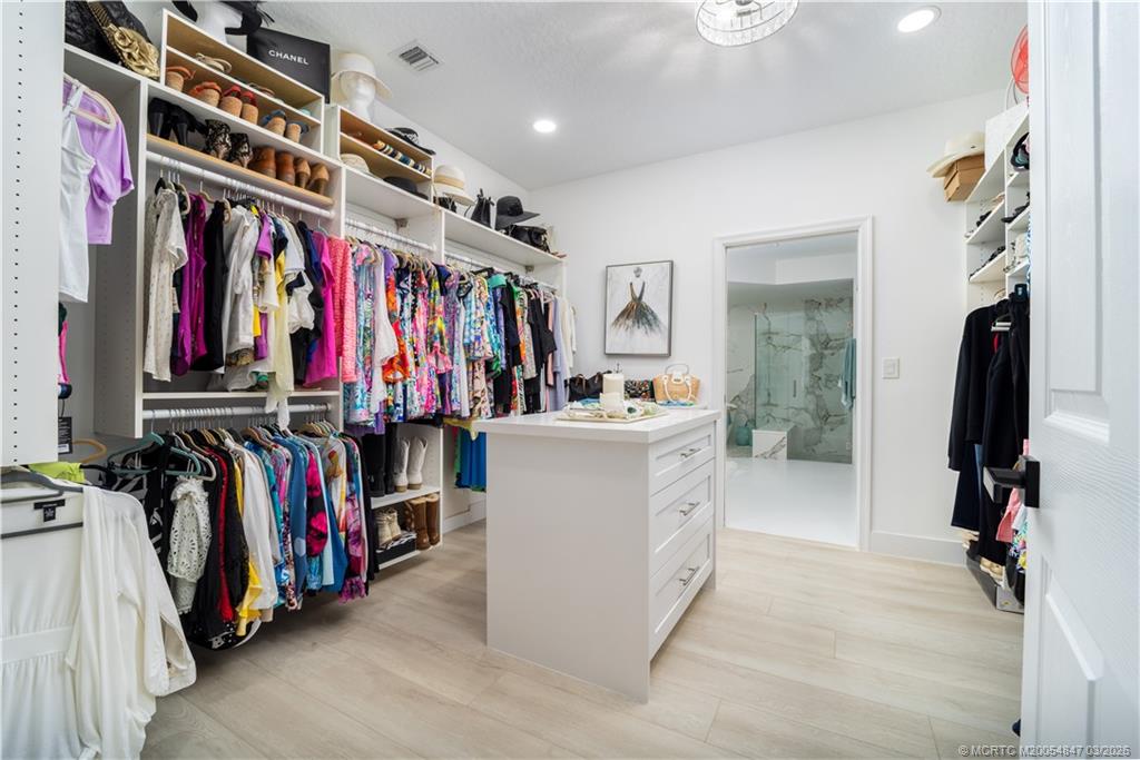 1257 Southeast Brewster Place Stuart, FL 34997 - Photo 22 of 35 a view of walk in closet with clothes and shoes