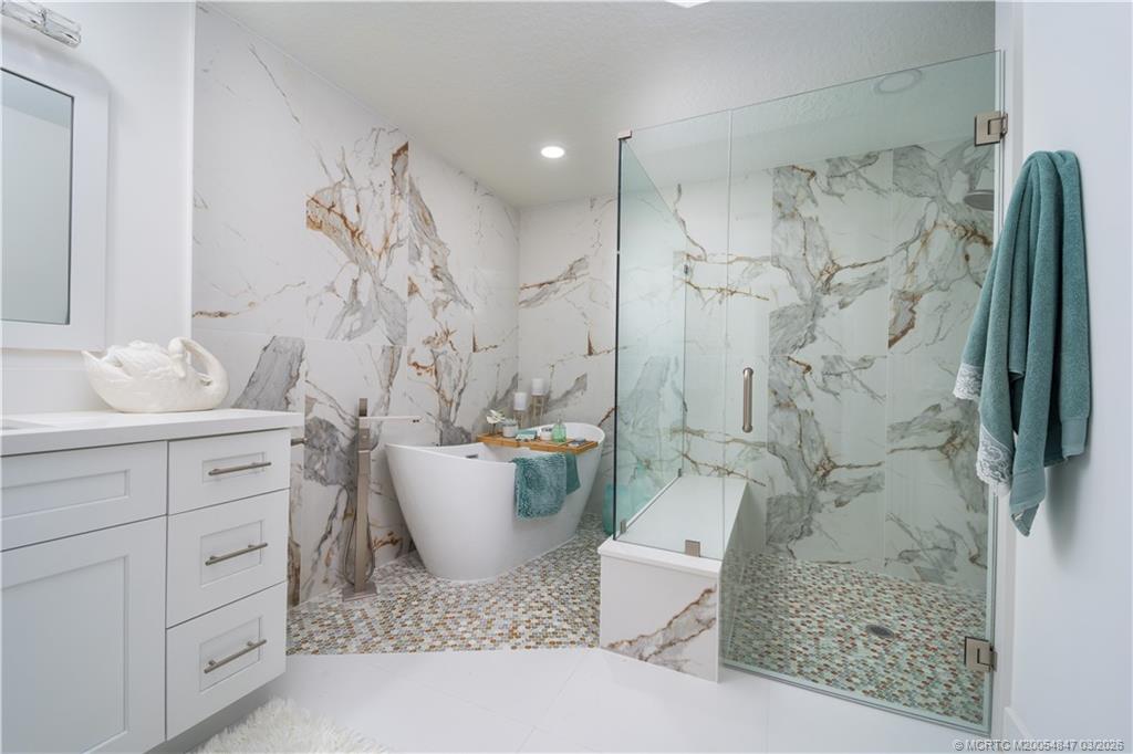1257 Southeast Brewster Place Stuart, FL 34997 - Photo 24 of 35 a bathroom with a bathtub sink and toilet