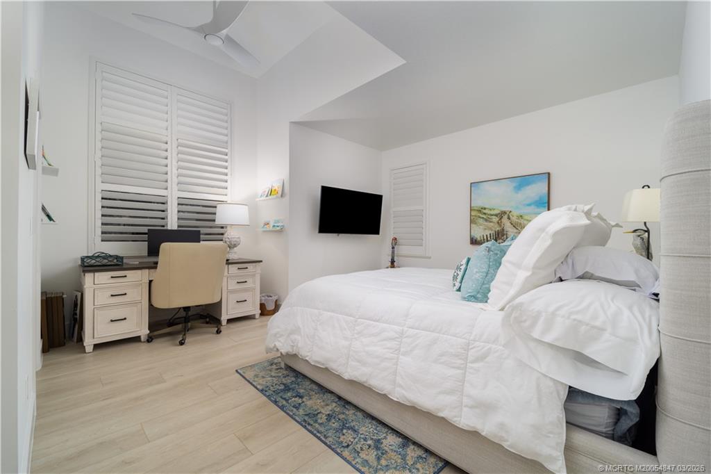 1257 Southeast Brewster Place Stuart, FL 34997 - Photo 29 of 35 a bedroom with a bed and large tv