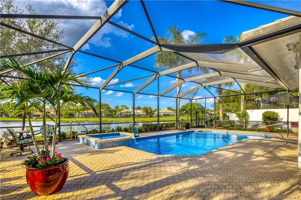 1257 Southeast Brewster Place Stuart, FL 34997 - Photo 34 of 35 a view of a swimming pool with a lounge chairs