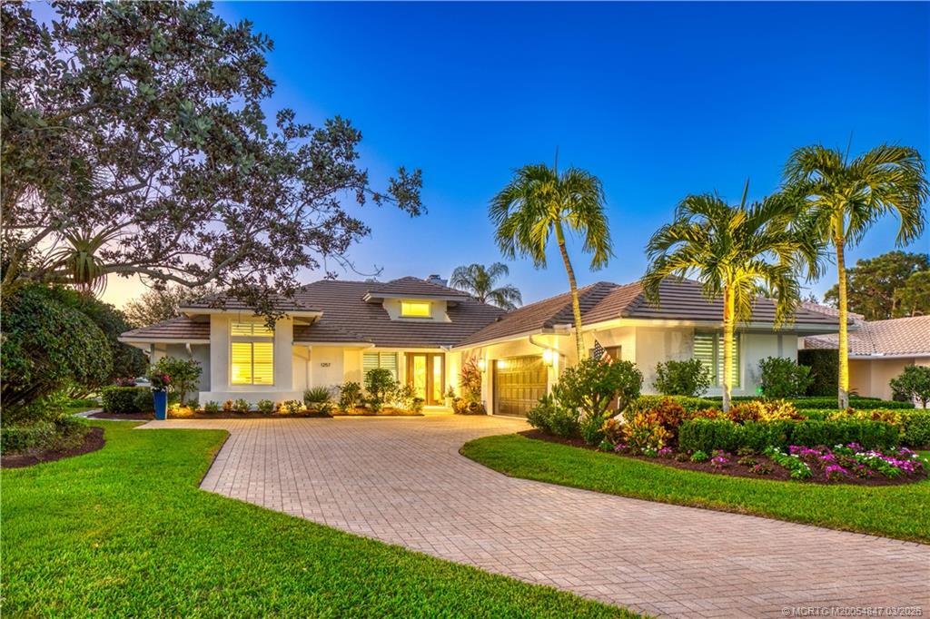 1257 Southeast Brewster Place Stuart, FL 34997 - Photo 6 of 35 a view of a house with palm trees