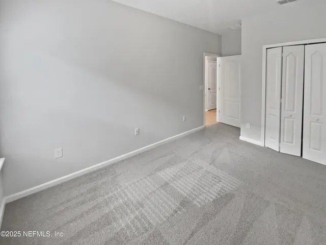 en empty room with white walls and tiles