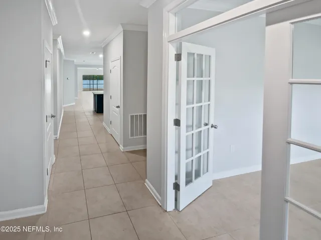 a spacious bedroom with a bed and a flat screen tv