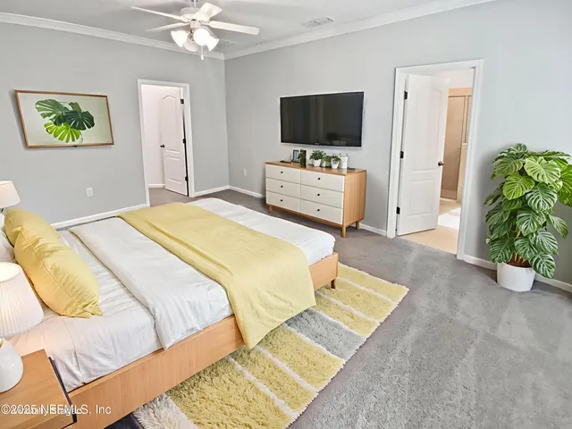 a view of an empty room with a chandelier fan