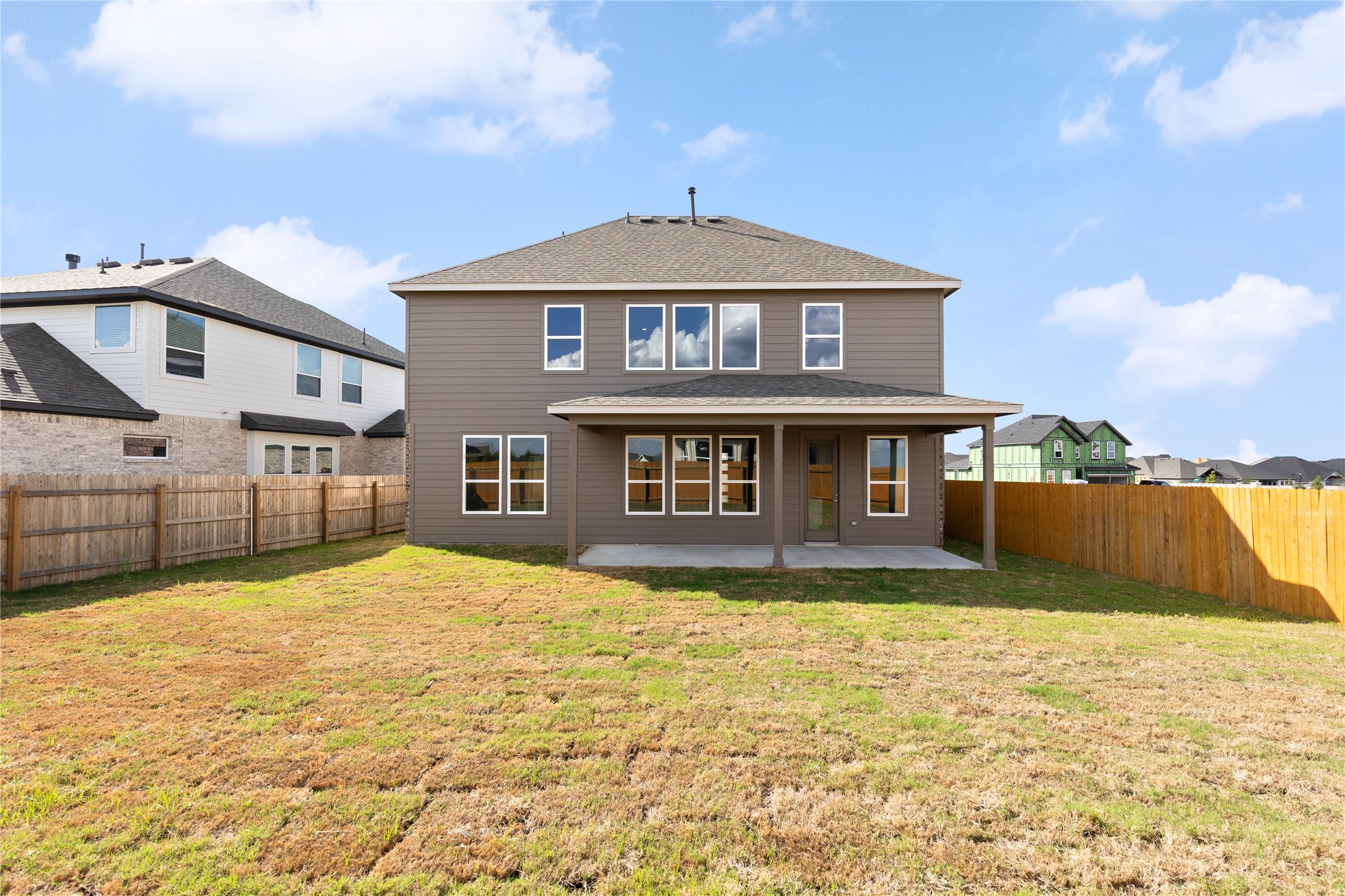 19705 Domino Champ Road Pflugerville, TX 78660 - Photo 38 of 38 A spacious grassy lawn sits within a fully fenced backyard behind this two-story home.