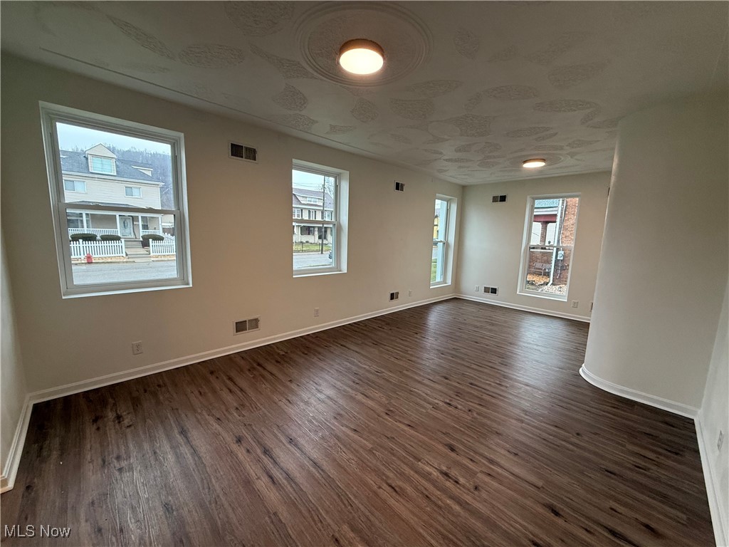522 North 3rd Street Toronto, OH 43964 - Photo 4 of 47 Empty room featuring dark wood-type flooring and baseboards