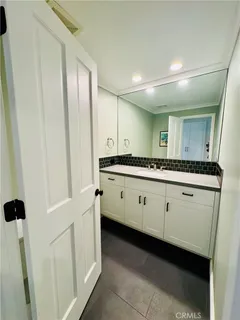 a bathroom with a double vanity sink and mirror