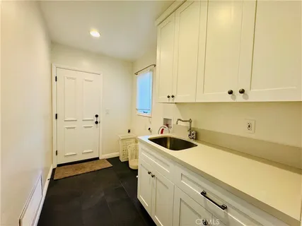a view of a kitchen with white cabinets