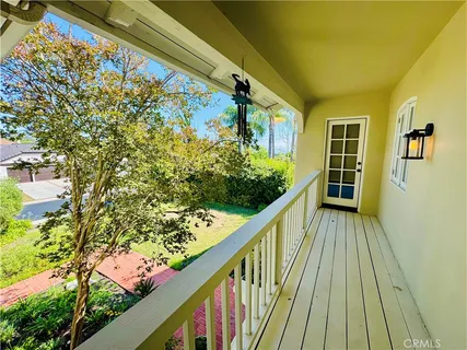 a view of balcony with wooden floor