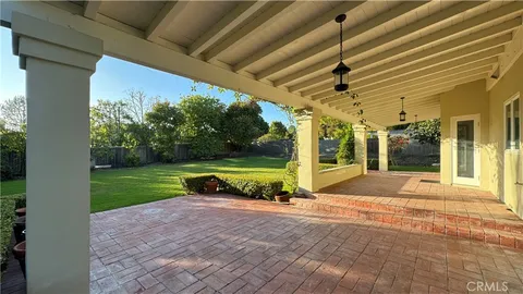 a view of a porch with yard and a garage