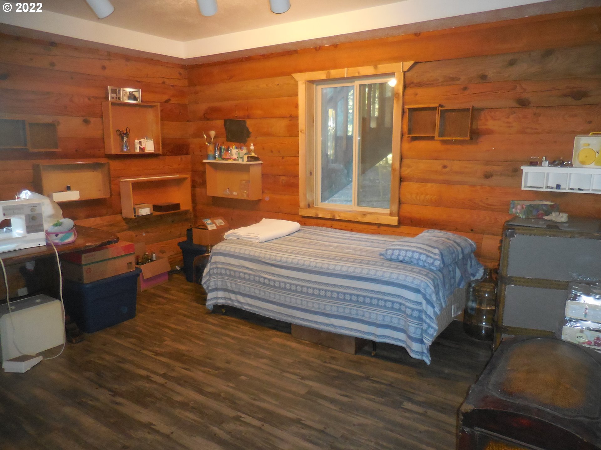 18480 Falls City Road Dallas, OR 97338 - Photo 23 of 32 a bedroom with a bed and wooden floor