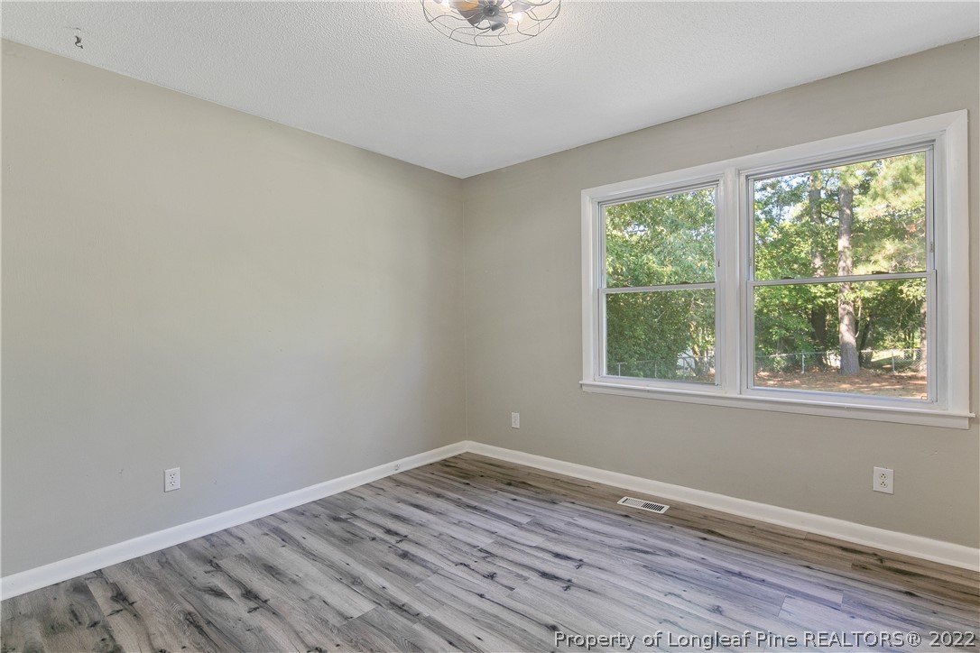 711 Bronco Road Fayetteville, NC 28303 - Photo 22 of 42 wooden floor in an empty room with a window