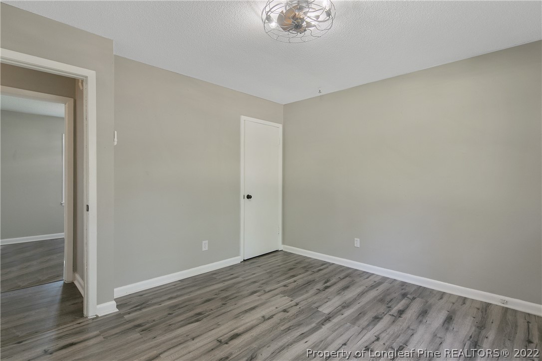 711 Bronco Road Fayetteville, NC 28303 - Photo 25 of 42 a view of an empty room with wooden floor
