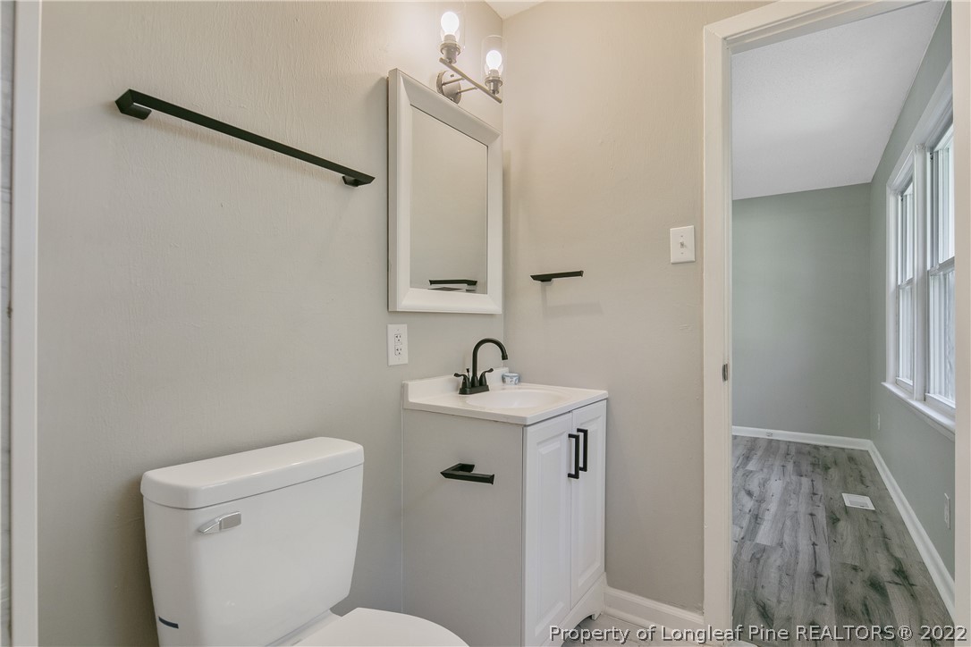 711 Bronco Road Fayetteville, NC 28303 - Photo 28 of 42 a bathroom with a toilet sink and a mirror