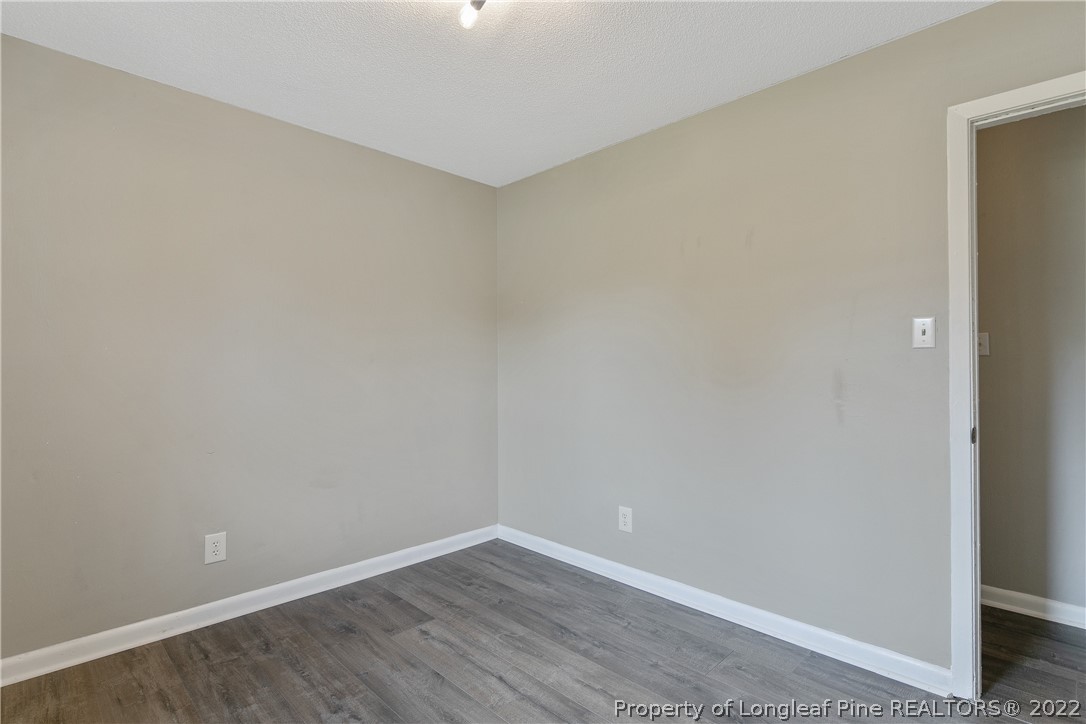 711 Bronco Road Fayetteville, NC 28303 - Photo 30 of 42 a view of an empty room with wooden floor