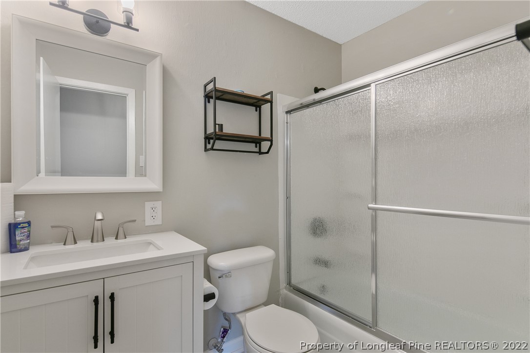 711 Bronco Road Fayetteville, NC 28303 - Photo 33 of 42 a bathroom with a toilet a sink and shower