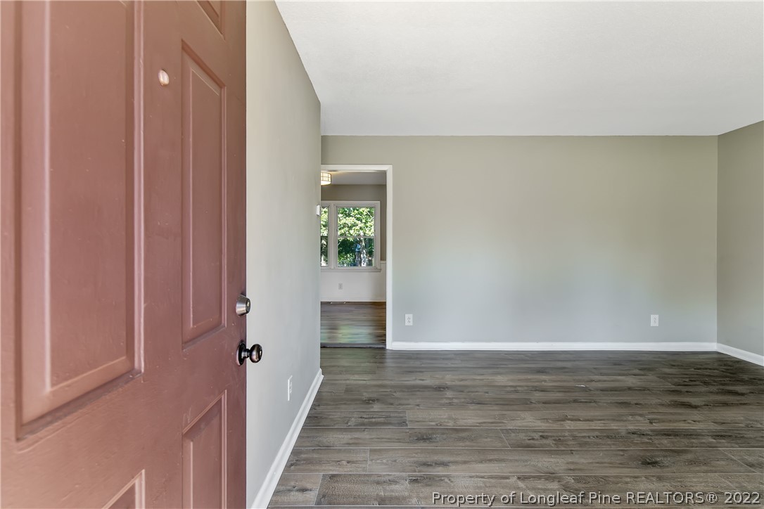 711 Bronco Road Fayetteville, NC 28303 - Photo 5 of 42 a view of an empty room with wooden floor