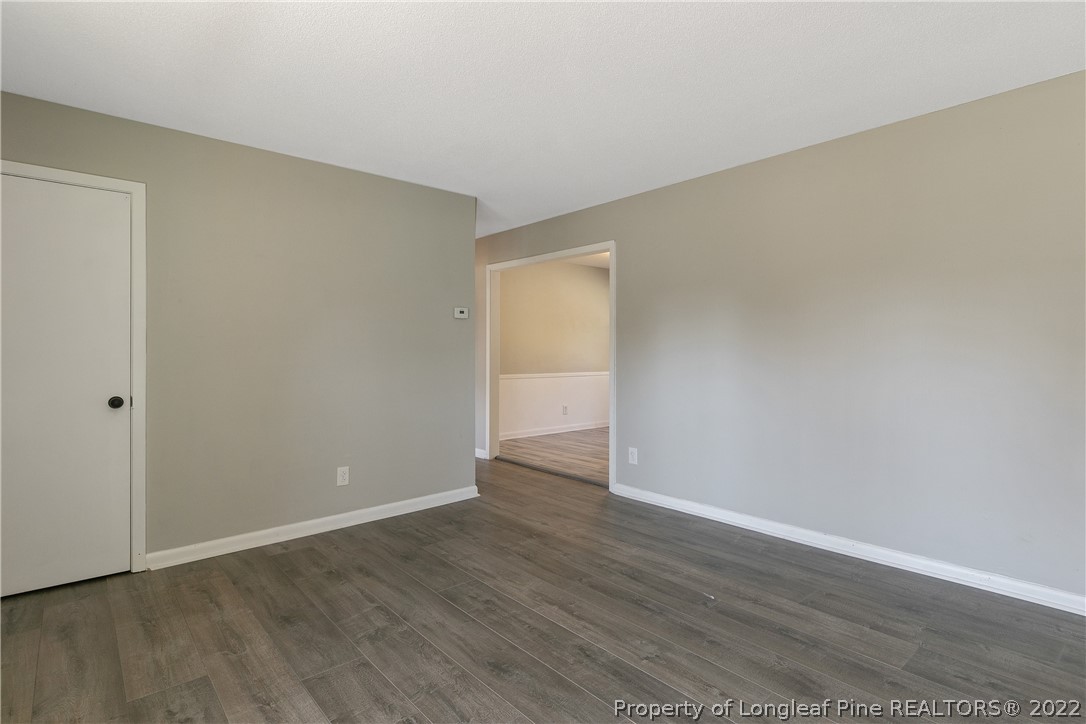 711 Bronco Road Fayetteville, NC 28303 - Photo 9 of 42 a view of an empty room with wooden floor
