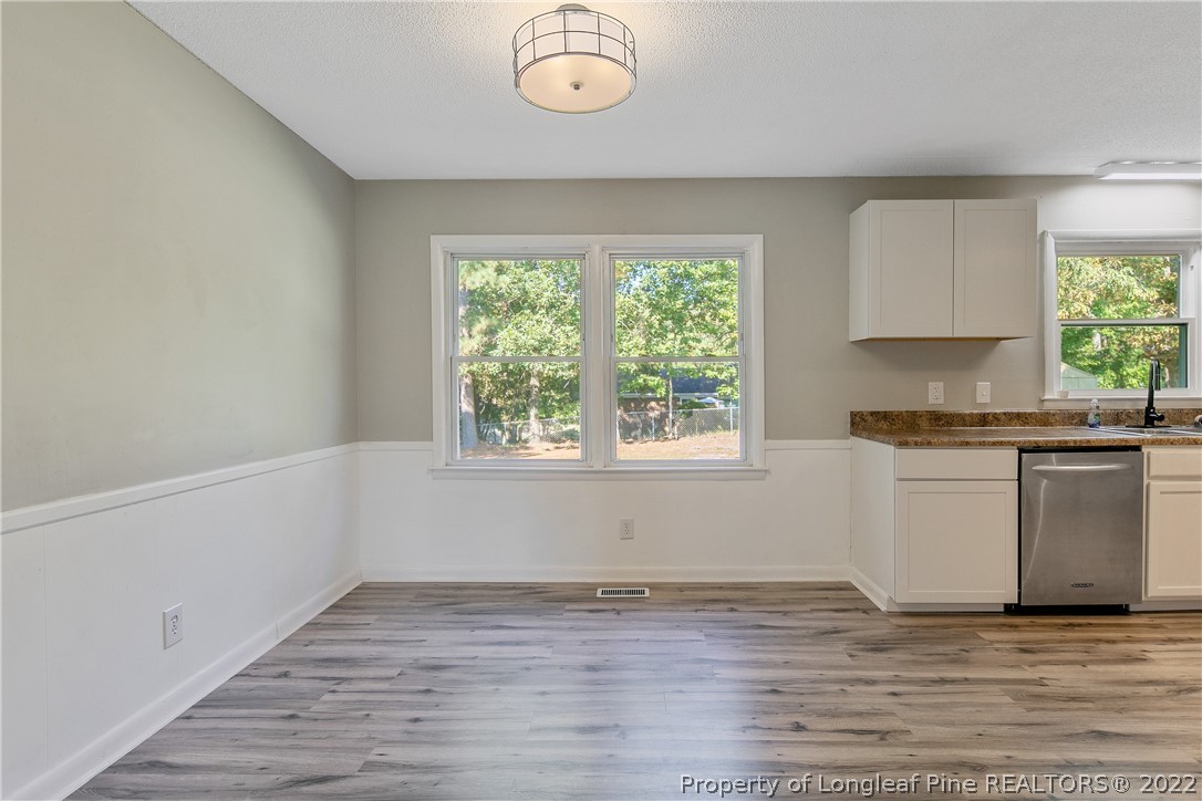 711 Bronco Road Fayetteville, NC 28303 - Photo 10 of 42 an empty room with wooden floor and window