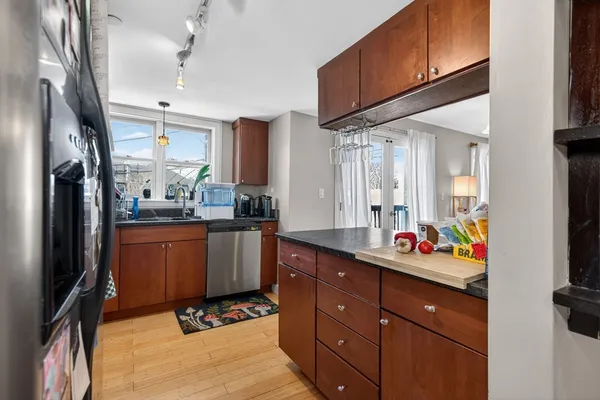a kitchen with a sink appliances and cabinets