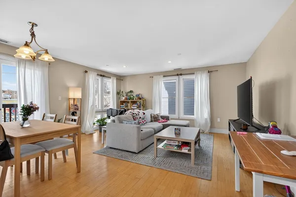 a living room with furniture window and wooden floor