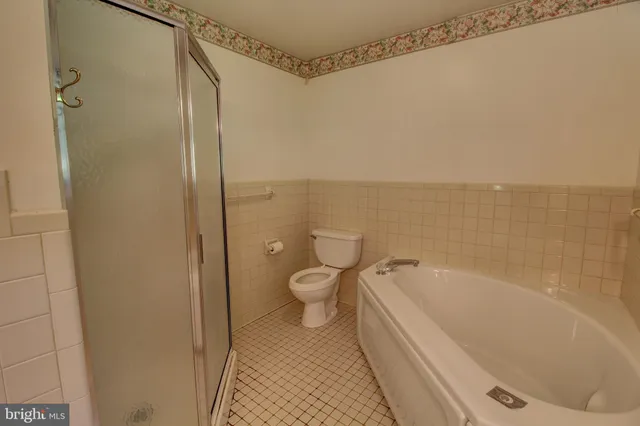 a bathroom with a tub sink and a mirror