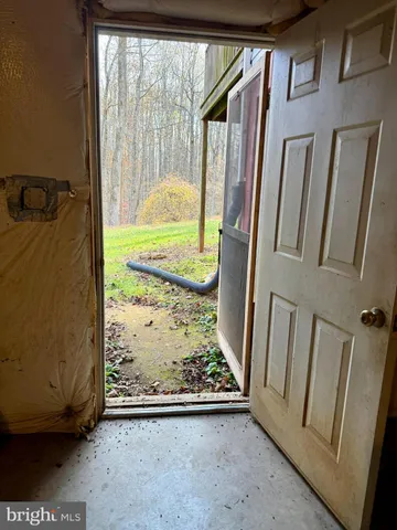 a view of green field with trees in the background