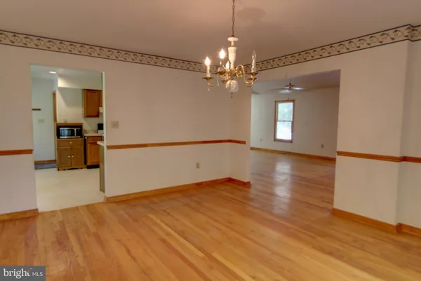 wooden floor fireplace and windows in an empty room