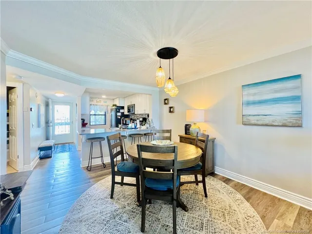 a view of a dining room and a table and chairs