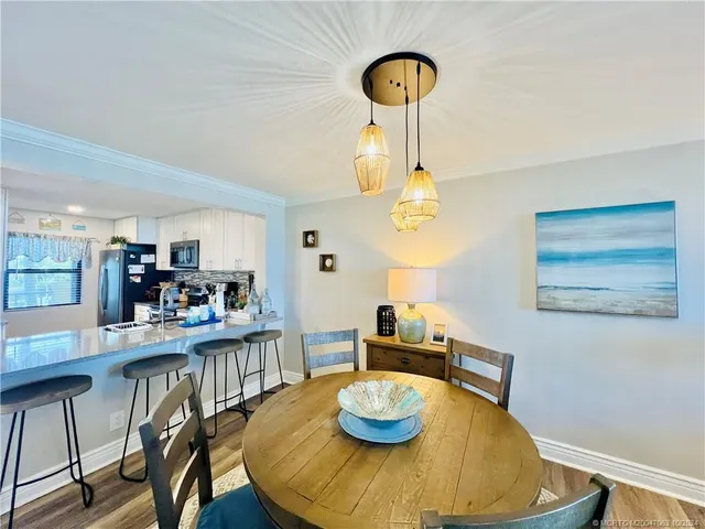 a view of a dining room with furniture and chandelier