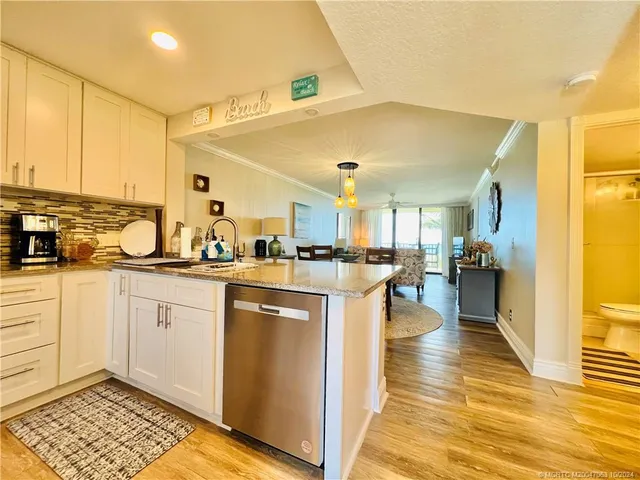 a kitchen with stainless steel appliances granite countertop a refrigerator stove and sink